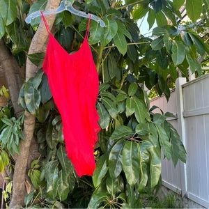 Vintage red bodysuit with sheer detailing along the hem and floral design